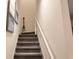 Carpeted staircase with white railing and decorative paddle accent piece at 10437 Ebb Tide Ln, Orlando, FL 32821