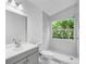 Clean and bright bathroom featuring new tile, fixtures, and a window providing great natural light at 1136 Twin Rivers Blvd, Oviedo, FL 32766