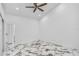 White bedroom showing ceiling fan, white walls and white marble-look floor tiles at 1136 Twin Rivers Blvd, Oviedo, FL 32766