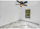 Bedroom featuring a ceiling fan, fresh white paint, marble floors, and a window overlooking a lovely outdoor view at 1136 Twin Rivers Blvd, Oviedo, FL 32766