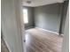 Cozy bedroom featuring laminate flooring, neutral walls, and natural light from the window at 1303 37Th Nw St, Winter Haven, FL 33881