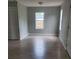 A bright bedroom featuring laminate flooring, a closet, and a window at 1303 37Th Nw St, Winter Haven, FL 33881