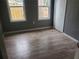 Comfortable bedroom featuring laminate flooring, closet, and natural light at 1303 37Th Nw St, Winter Haven, FL 33881