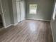 A bright bedroom featuring laminate flooring, a closet, and a window at 1303 37Th Nw St, Winter Haven, FL 33881