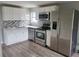 Modern kitchen featuring stainless steel appliances, white cabinets and backsplash at 1303 37Th Nw St, Winter Haven, FL 33881