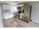 Modern kitchen featuring stainless steel appliances, white cabinets and backsplash at 1303 37Th Nw St, Winter Haven, FL 33881