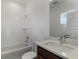 Bright bathroom featuring a shower-tub combo and a single-sink vanity with a stone countertop at 13062 Sunrise Harvest Dr, Winter Garden, FL 34787