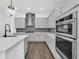 Bright kitchen with stainless steel appliances, a sleek backsplash, and modern white cabinetry at 13062 Sunrise Harvest Dr, Winter Garden, FL 34787