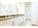 Bright bathroom featuring double sinks, stone countertops, and sleek white cabinetry at 13401 Panama Beach Ct, Orlando, FL 32827