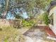 View of backyard with partial fence, mature trees, and landscaping at 1382 Wright St, Daytona Beach, FL 32117