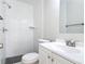 Bathroom with white tiled shower, black and white tiled floor, toilet, and vanity with sink at 1382 Wright St, Daytona Beach, FL 32117