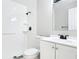 Bathroom with white tiled shower, black fixtures, a grab bar, toilet, and vanity with sink at 1382 Wright St, Daytona Beach, FL 32117