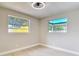 Bedroom with wood floors, two windows, and neutral decor at 1382 Wright St, Daytona Beach, FL 32117