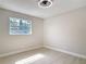 A bedroom featuring wood-look floors and a window looking out to the yard at 1382 Wright St, Daytona Beach, FL 32117