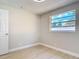 A bedroom featuring wood-look floors, a window, and white trim at 1382 Wright St, Daytona Beach, FL 32117