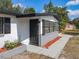 Front entrance and walkway leading up to the entry door and a garden area with mulch at 1382 Wright St, Daytona Beach, FL 32117