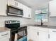 This remodeled kitchen features stainless steel appliances, white subway tiles, and modern fixtures at 1382 Wright St, Daytona Beach, FL 32117