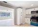 Modern kitchen featuring white cabinets, stainless steel appliances, and light wood flooring at 1382 Wright St, Daytona Beach, FL 32117