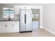 Bright kitchen featuring white cabinets, a stainless steel refrigerator, and light wood floors at 1382 Wright St, Daytona Beach, FL 32117