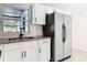 Bright kitchen featuring white cabinets, a stainless steel sink, and light wood flooring at 1382 Wright St, Daytona Beach, FL 32117