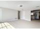 Bright living room featuring neutral paint, an open doorway to the kitchen, and light wood flooring at 1382 Wright St, Daytona Beach, FL 32117