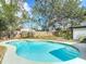 A beautifully in-ground pool surrounded by mature trees, providing a serene backyard escape at 1382 Wright St, Daytona Beach, FL 32117