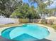 Backyard swimming pool with a tile border, surrounded by mature trees and privacy fencing at 1382 Wright St, Daytona Beach, FL 32117