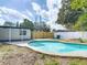 Outdoor pool with an adjacent covered patio area and fenced backyard at 1382 Wright St, Daytona Beach, FL 32117