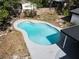 A kidney-shaped pool sparkles with a white concrete deck, mosaic waterline tile, and privacy fence at 1382 Wright St, Daytona Beach, FL 32117