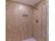 Shower with tiled walls and recessed shelving for toiletries at 1428 Oak Pl # J, Apopka, FL 32712