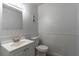 A well-lit bathroom featuring a vanity, toilet, and neutral color scheme providing a clean aesthetic at 1428 Oak Pl # J, Apopka, FL 32712