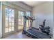 Bright patio with a treadmill and bike, perfect for enjoying the outdoors at 1428 Oak Pl # J, Apopka, FL 32712