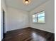 Bright bedroom with wood-look flooring and a large window overlooking the backyard at 15052 Mayberry Dr, Winter Garden, FL 34787