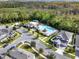 Overhead shot of a community pool area including a pergola, picnic area, and mature trees next to modern homes at 15052 Mayberry Dr, Winter Garden, FL 34787