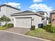 Detached two car garage with a neutral color and a well maintained driveway at 15052 Mayberry Dr, Winter Garden, FL 34787