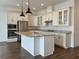 Modern kitchen with a large center island, stainless steel appliances, and bright white cabinetry at 15052 Mayberry Dr, Winter Garden, FL 34787