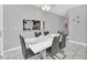 Bright dining area with a large mirror, modern table setting, and contemporary decor at 1569 Plunker Dr, Davenport, FL 33896