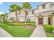 Charming townhome exterior featuring lush tropical landscaping and a welcoming entrance at 1569 Plunker Dr, Davenport, FL 33896