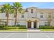 Exterior of a beautiful two-story condo building featuring a tile roof, and mature landscaping at 1569 Plunker Dr, Davenport, FL 33896