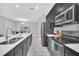 Kitchen featuring an island with seating, dark cabinetry, stainless steel appliances, and modern finishes at 1569 Plunker Dr, Davenport, FL 33896