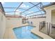 Sparkling pool with a safety fence and screened enclosure, ideal for Gathering fun and relaxation at 1569 Plunker Dr, Davenport, FL 33896