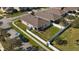 Aerial view showcasing a backyard with white fence, green lawn, and a screened-in patio at 1619 Leatherback Ln, St Cloud, FL 34771