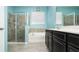 Bright bathroom with a shower and soaking tub, offering a relaxing retreat with modern fixtures and a tiled floor at 1619 Leatherback Ln, St Cloud, FL 34771