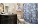 Cozy bathroom with a vanity, toilet and shower with a seashell-themed curtain at 1619 Leatherback Ln, St Cloud, FL 34771