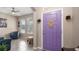 Charming entryway features a vibrant purple door and opens to a cozy living space with ample natural light at 1619 Leatherback Ln, St Cloud, FL 34771