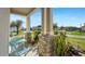 Inviting front porch area with stone details, plants and a small table with two chairs at 1619 Leatherback Ln, St Cloud, FL 34771