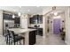 Modern kitchen showcases dark cabinetry, stainless steel appliances, granite counters, and a functional center island at 1619 Leatherback Ln, St Cloud, FL 34771