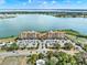 Expansive aerial view showcases a lakeside resort with lush landscaping, parking, and a scenic backdrop at 16300 County Road 455 # 201, Montverde, FL 34756