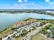 Stunning aerial view of lakefront condo community with beautiful landscaping and ample parking at 16300 County Road 455 # 201, Montverde, FL 34756