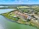 Beautiful aerial view of condo community, pool, and lakefront property on a sunny day at 16300 County Road 455 # 201, Montverde, FL 34756